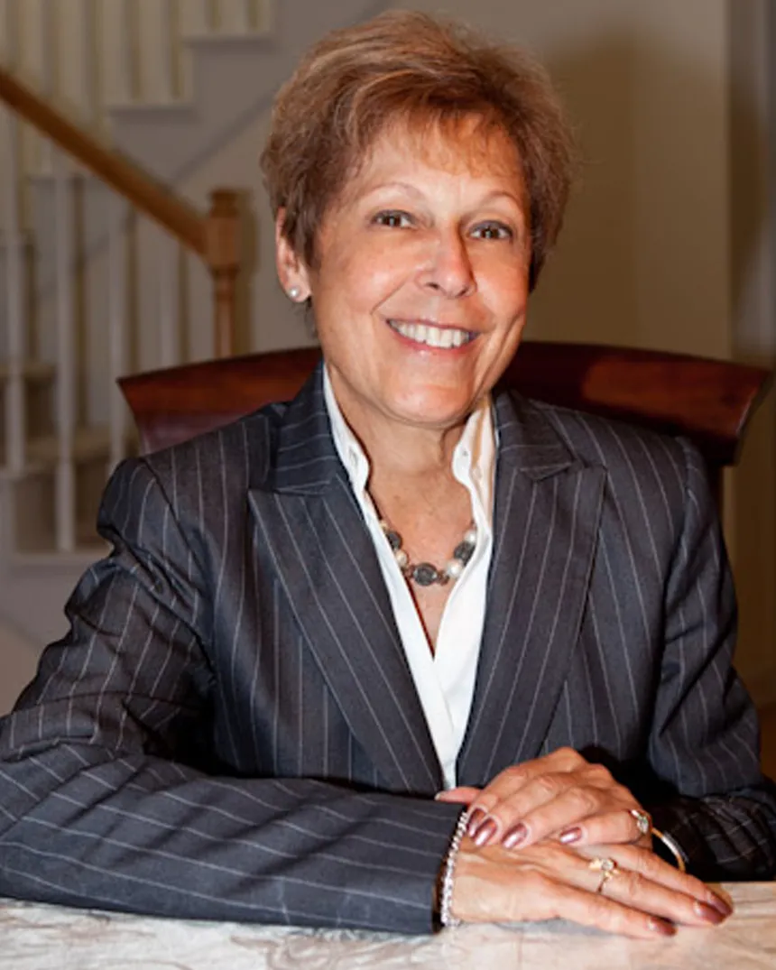 Cheryl A. Scharoun, RN, BSN, BCPA, smiling at her dining table
